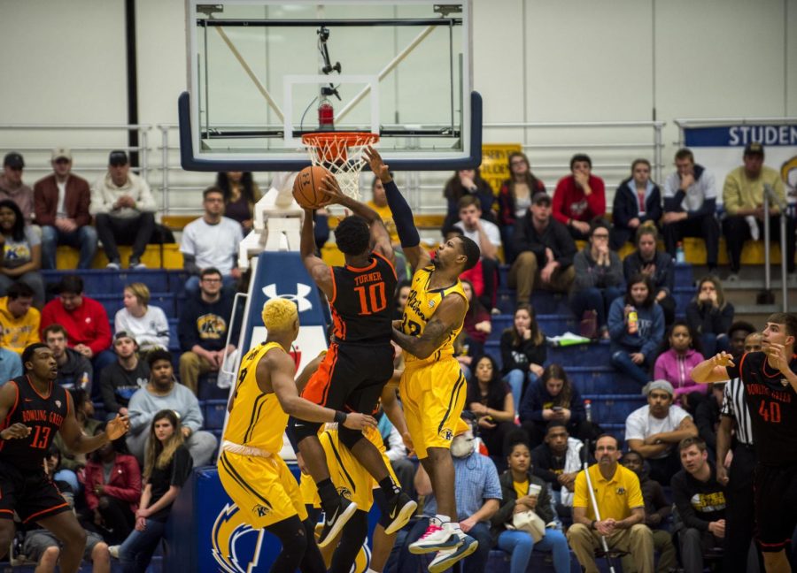 Kent State senior guard Desmond Ridenour rises to block an attempt by Bowling Green's Justin Turner on Feb. 24. The Flashes won on last-second free throws, 64-63. [FILE]