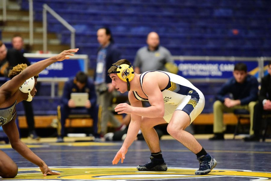 Freshman wrestler Jake Ferri prepares to grapple with an opposing wrestler. Ferri is one of four freshmen in Kent State's starting lineup this season. 