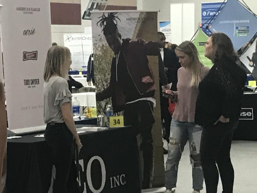 Students look over American Eagle's table at the Spring Internship, Co-op and Career Fair Thursday, Feb. 22, 2018.