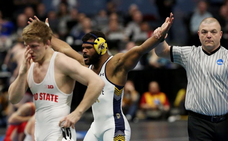 Kent State wrestler Kyle Conel celebrates after pinning No. 1 seed Kollin Moore of Ohio State at the NCAA Wrestling Championships at Quicken Loans Arena on March 16, 2018. Conel's victory earned him a spot in the Flashes' record books as the only unseeded all-American in school history.