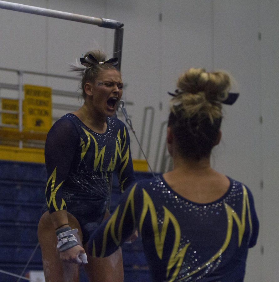 Kent State senior gymnast Rachel Stypinski finishes her bar routine during the Flashes' win at the Kent State Tri-Meet on March 16, 2018. Stypinski left the meet due to injury.