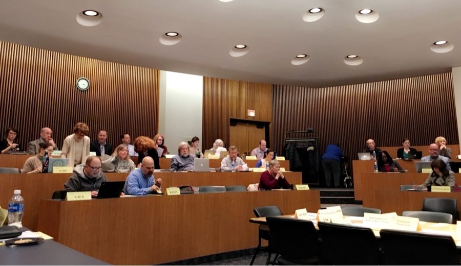 Faculty Senate members settle into their seats as their monthly meeting kicks off in the Governance Chambers Monday, March 12, 2018.