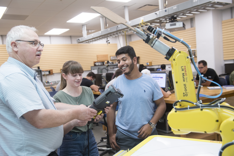 FANUC arm Professor Darwin Boyd and two of his students.