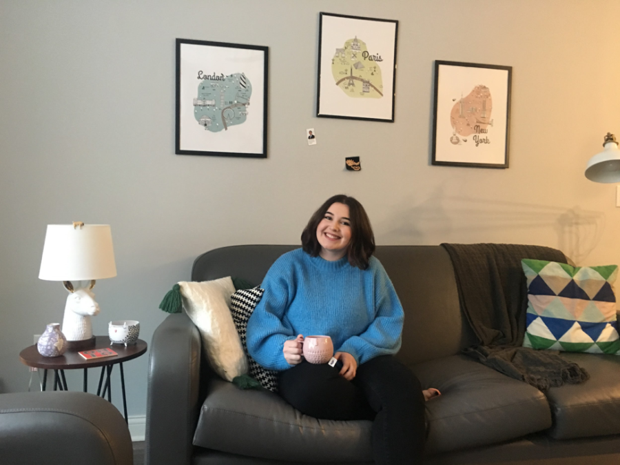 Margaret Fisher poses in the living area of her 345 Flats apartment.