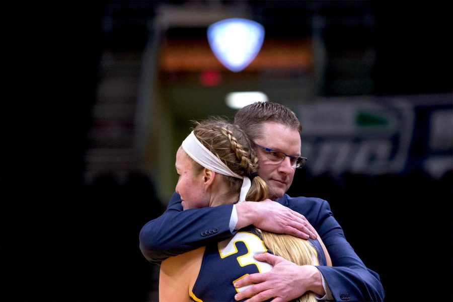 Kent State senior forward Jordan Korinek and coach Todd Starkey share an embrace after being subbed out of the Flashes' 72-50 loss against Buffalo in the MAC Tournament March 7, 2018.