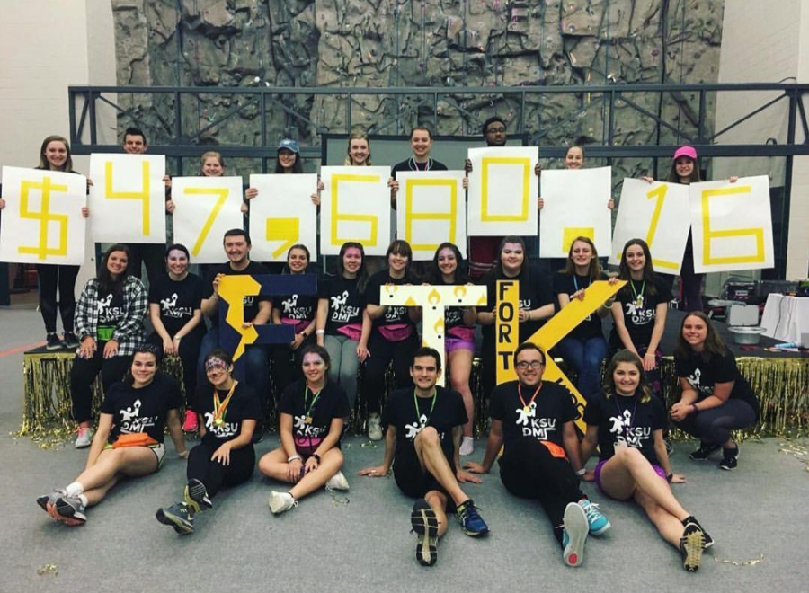 Participants of Kent State's sixth annual Flashathon pose with the total amount raised Saturday, April 7, 2018. 