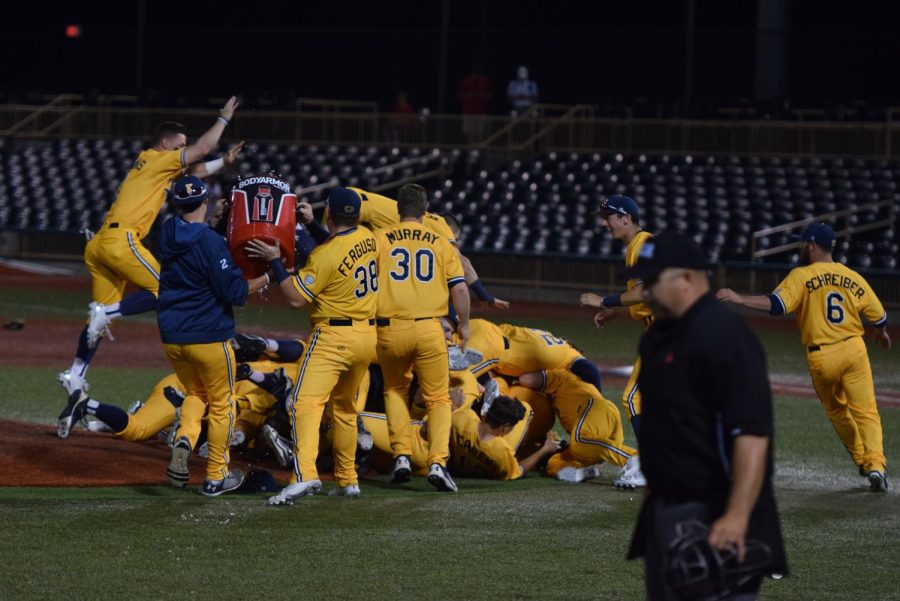 The Kent State baseball team jumps on top of senior pitcher Eli Kraus following the Flashes' 14-0 win in the MAC Championship game on May 27, 2018. Kraus threw a two-hit complete game shutout, striking out 12. 