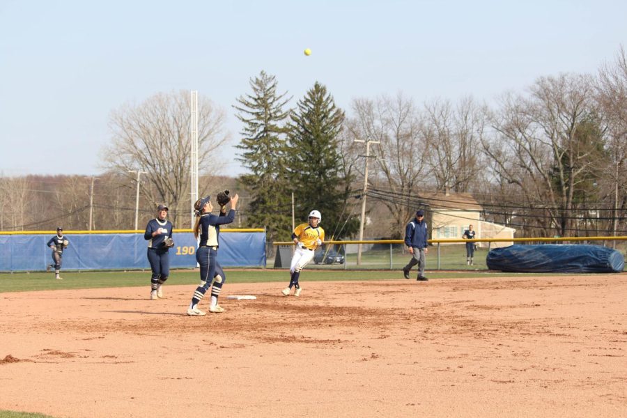 Kent State junior Sydney Anderson rounds the bases as Pitt shortstop Olivia Gray catches a fly ball during the Flashes' 6-4 loss on April 18, 2018.