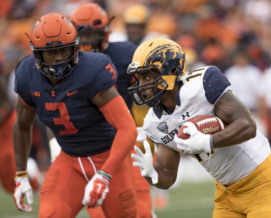 Kent State running back Justin Rankin rushes past Illinois' Del'Shawn Phillips in the second half of their game against Illinois at Memorial Stadium on Sept. 1, 2018. The Flashes lost to Illinois 31-24.