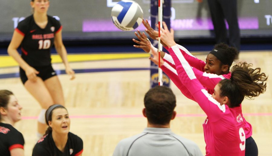 Then junior Lexi Mantas, 9, and then sophomore Myla King block the net during the volleyball game against Ball State on Oct. 13, 2017 in the M.A.C Center. Kent lost 1-3.