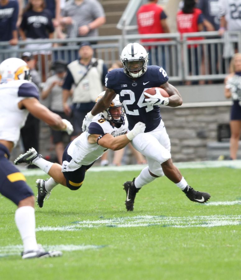 Kent State’s Matt Bahr tackles Penn State’s Miles Sanders during the first half of their matchup on Sept. 15, 2018. Kent State lost 63-10.