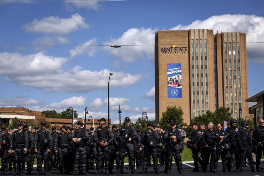 Police officers keep watch over the Schwartz Center parking lot as it fills with open-carry advocates. 