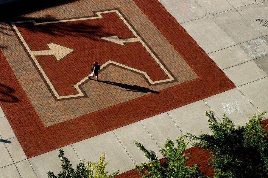 A student walks across the "K" at Risman Plaza on campus of Kent State University the evening of September 5, 2018. 