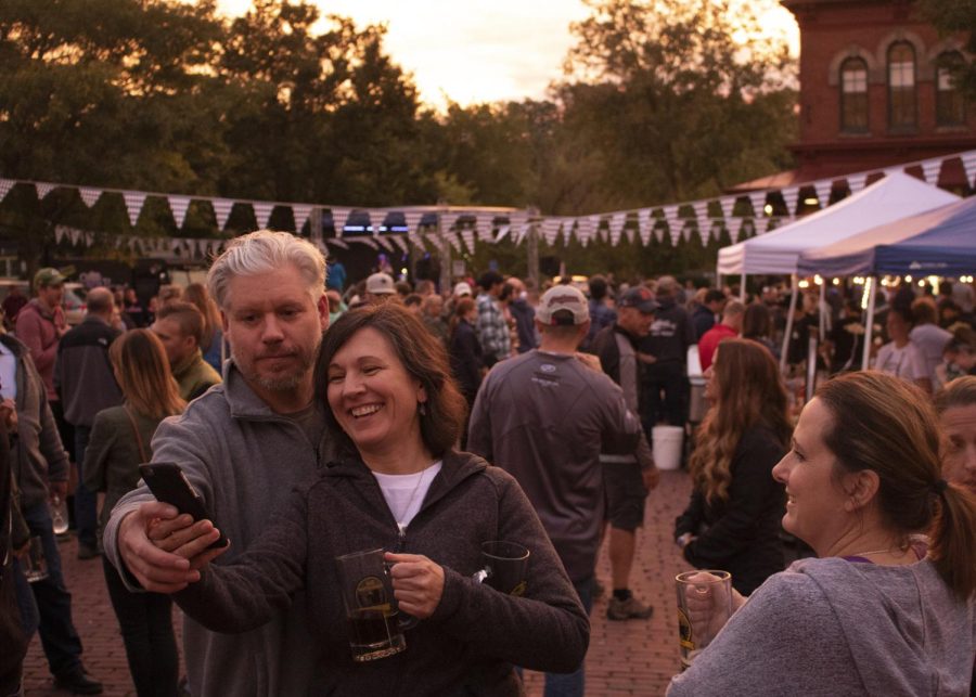 A couple takes a selfie in the middle of Kent Main Street's Oktoberfest crowd on September 24, 2018.