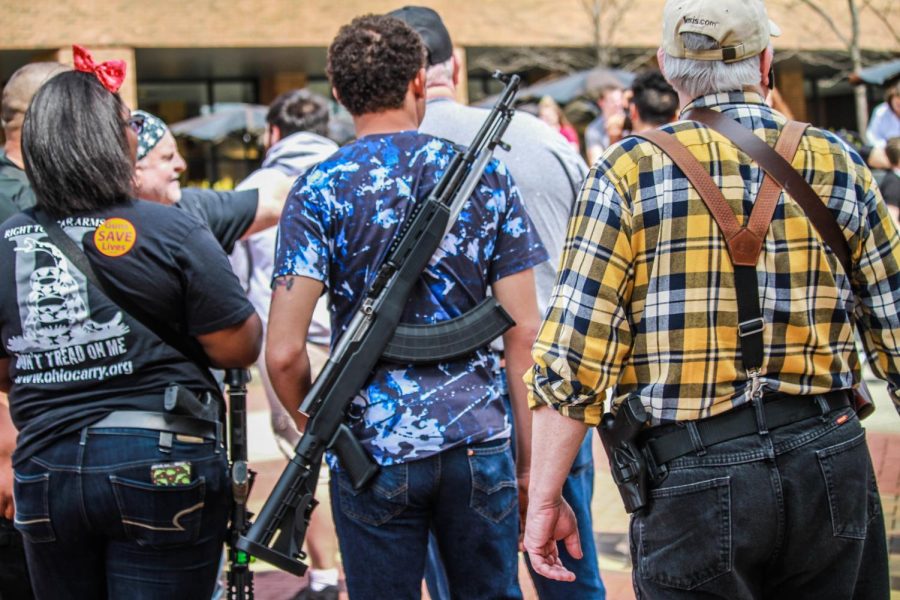 Demonstrators stand together in support of the second amendment and gun rights on Friday, April 27.