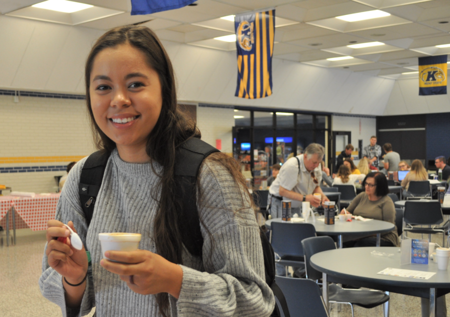 A student taste testing a cup of chili at Kent Tuscarwas' chili cookoff to celebrate Kent's 100 years of Homecoming. 