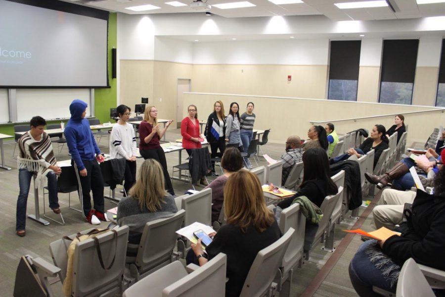 Megan "Meggie" Cale, anminternational student and scholar advisor, Sarah Schmidt, the outreach program coordinator of Global Education Initiatives and a group of international students interact with attendees after the ACIREMA workshop on Oct. 26.