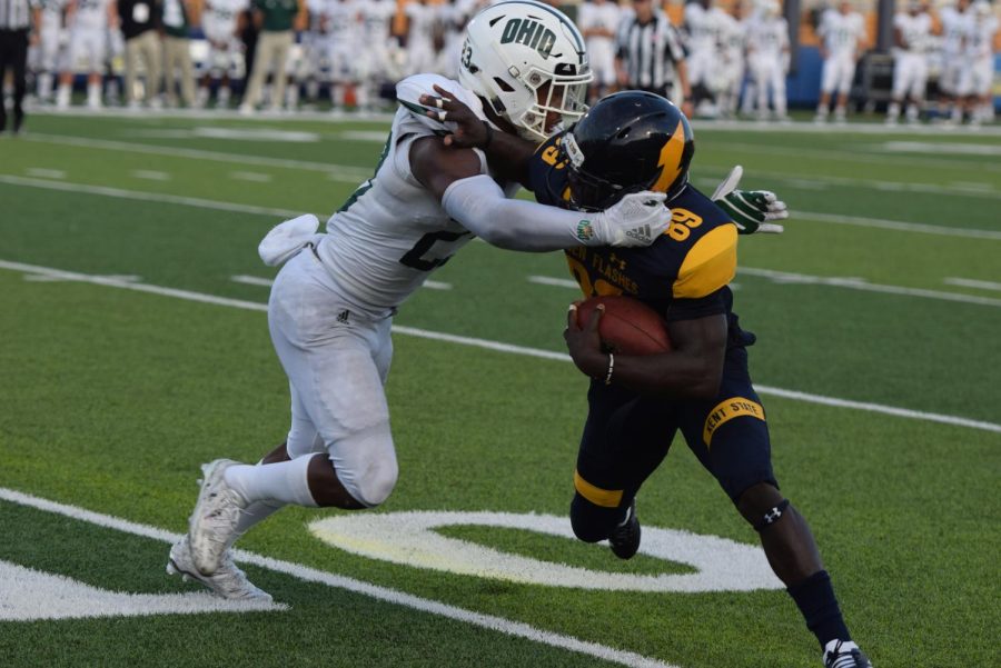 Kent State's Antwan Dixon attempts a stiff-arm during the second half of the Flashes matchup against Ohio University on Oct. 6, 2018. Kent lost the game, 27-26.