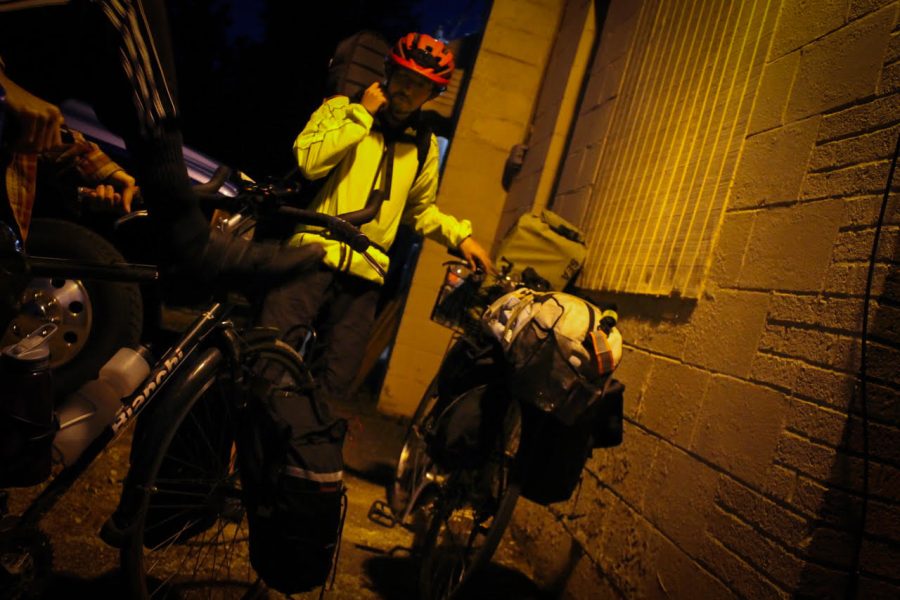 Hugh Yamada prepares to cycle to their show Friday, Sept. 28.