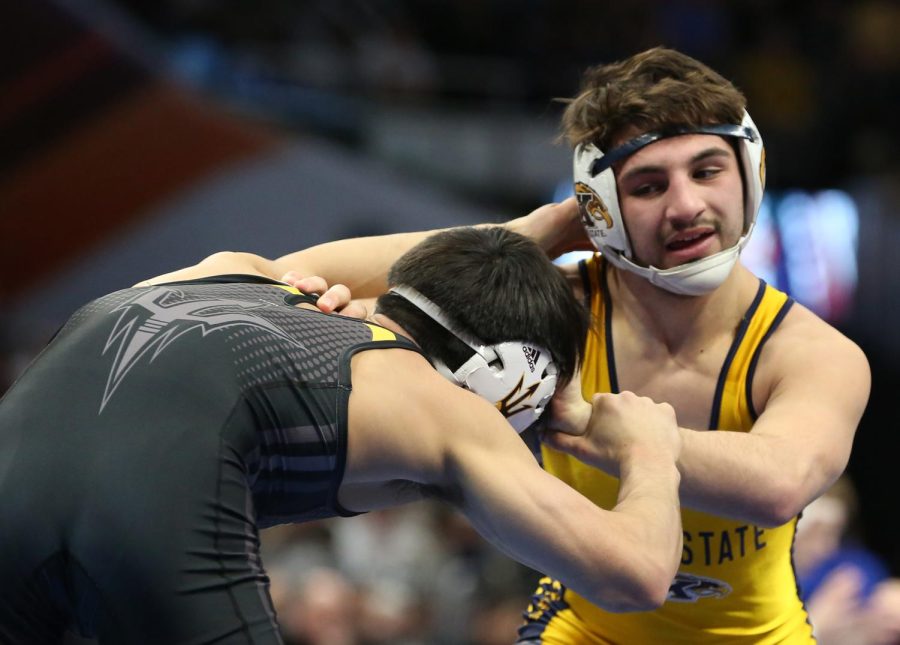 Kent State wrestler Anthony Tutolo grapples with Arizona State's Ali Naser during the NCAA Wrestling Championships at Quicken Loans Arena on March 15, 2018. 