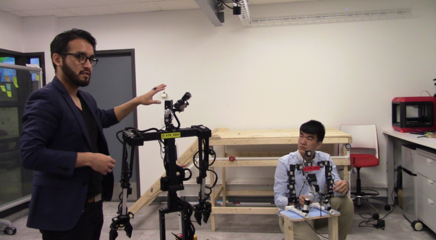 Irvin Cardenas (left) and Xiangxu Lin (right) pose with TeleBot 2.