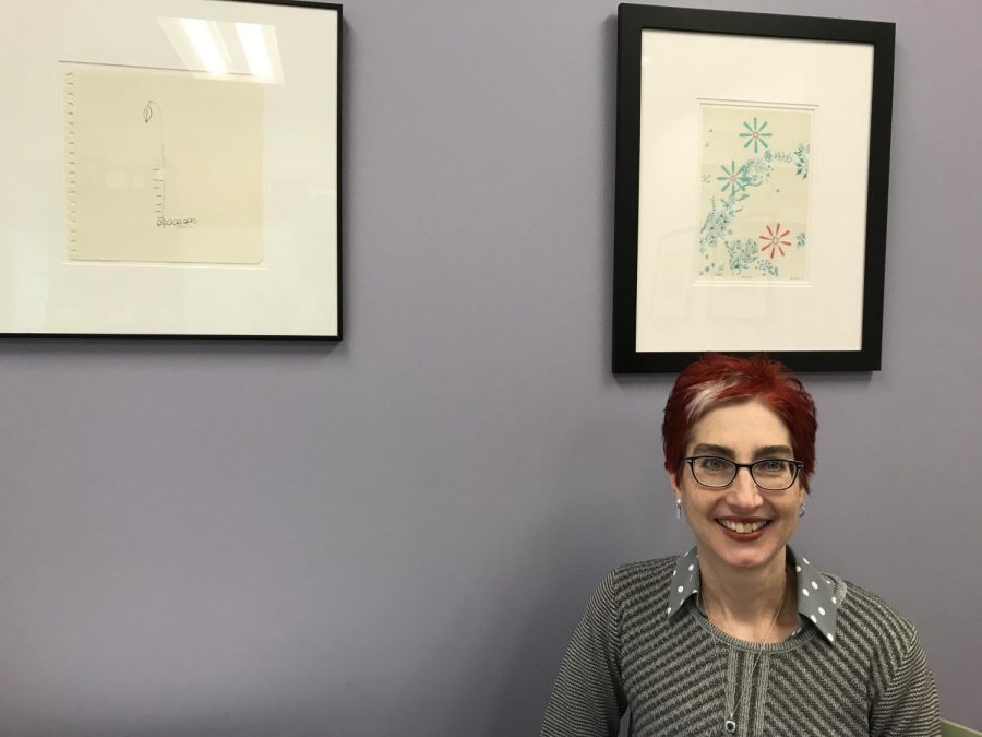 Marie Bukowski sits in her office in the Center for the Visual Arts on Tuesday, Nov. 27, 2018, where her artwork is framed.Bukowski began practicing visual and performance art as a child. Her family included art in her education as early as 6 or 7 years old, but she didn’t decide to pursue art professionally until high school. Bukowski earned her first degree in fine arts from Carnegie Mellon University. Now, Bukowski is the director of Kent State’s School of Art, and she has shown her printmaking work in local and international exhibits.