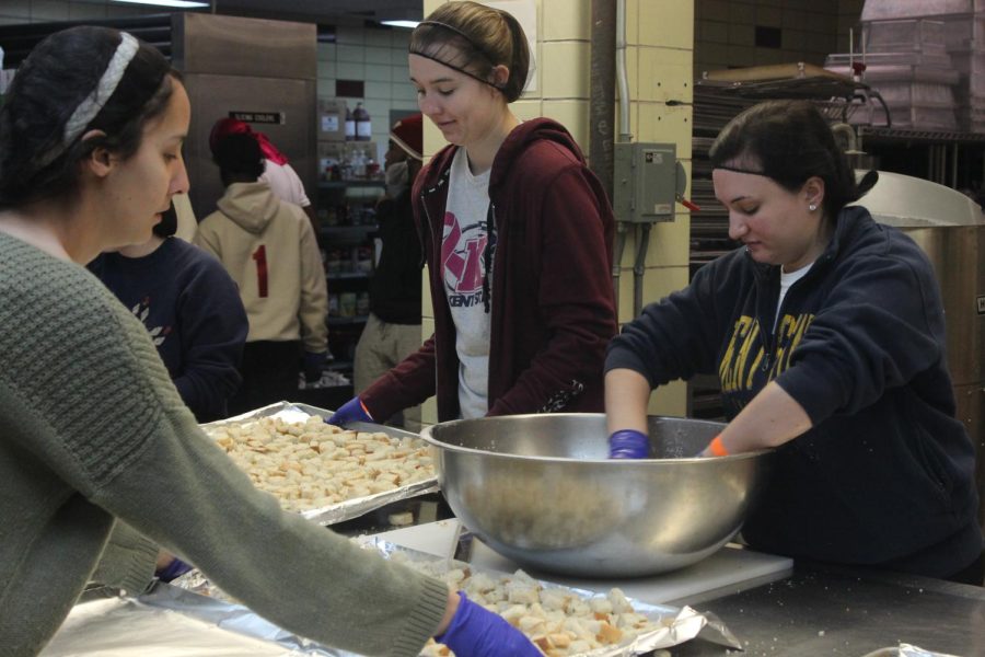 Maria Zaynor, a senior managerial marketing major, Lizzi Petrey, a sophomore sign language interpreting major, Rebecca Dillon, a senior exercise science major and Marisa Stephens, a senior managerial marketing major, prepare bread for croutons on Jan. 15, 2018. 