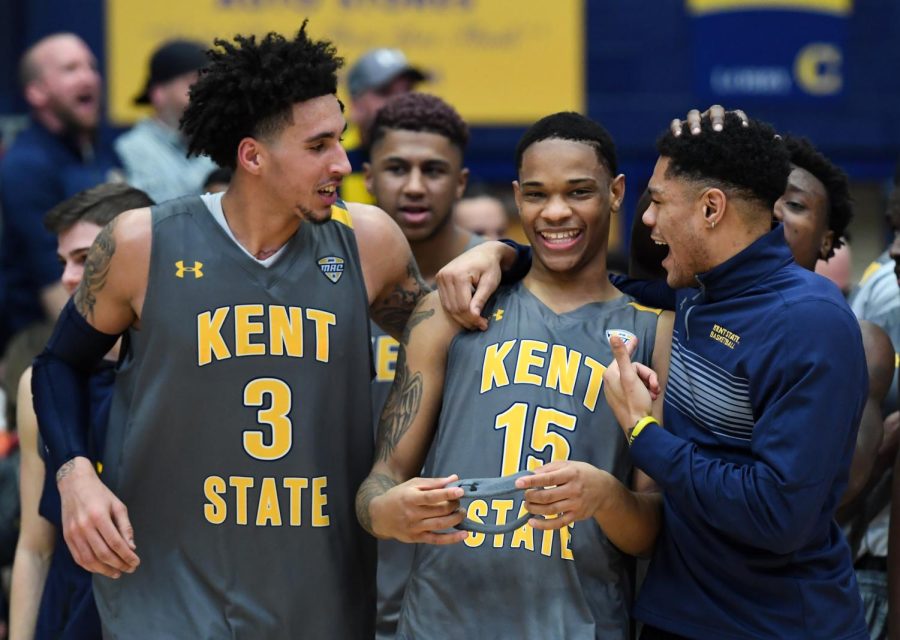 Kent State's Anthony Roberts (15) celebrates with Akiean Frederick (3) and Troy Simmons after defeating Toledo 87-85 in overtime, Tuesday at the M.A.C. Center.