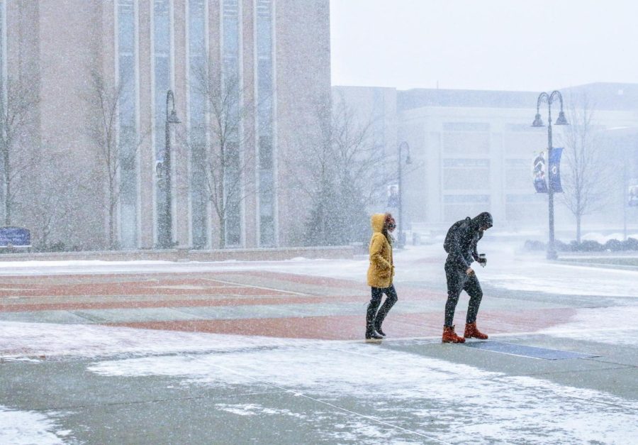 Students walk across Risman Plaza on Kent State's main campus and battle the frigid cold on Tuesday, Jan. 29, 2019.