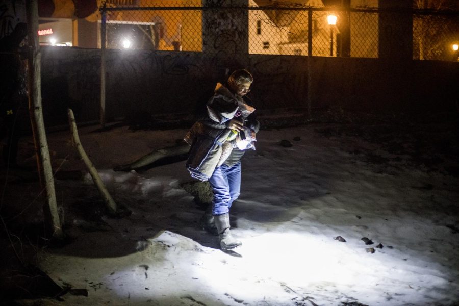 Mark Miller, the pastor of Portage Community Chapel, walks underneath the Haymaker Parkway bridge on Tuesday, Jan. 29, 2019, to drop off supplies to the people living in tent shelters in Kent. 