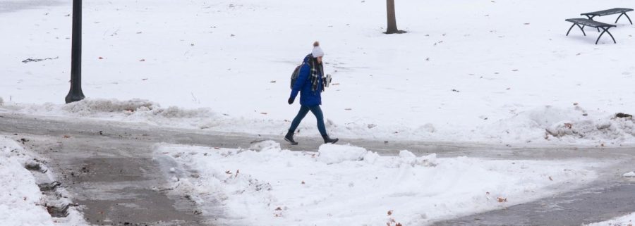 A Kent State student walks along Kent State's front campus on Tuesday, Jan. 29, 2019.