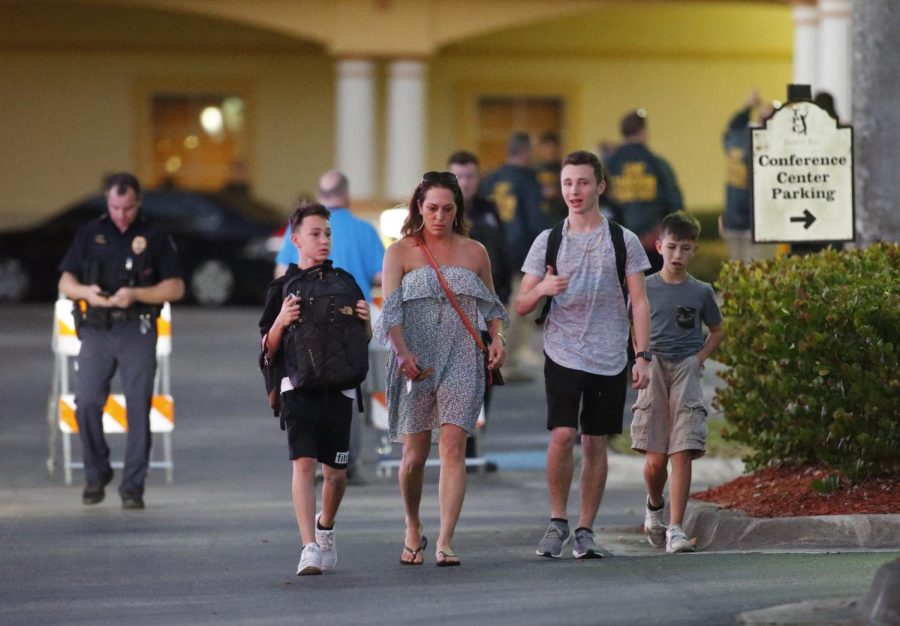 Family members pick up students of Marjory Stoneman Douglas High School in Parkland, Fla., at a nearby hotel, Wednesday, Feb. 14, 2018, in Coral Springs, Fla. A former student opened fire at the Florida high school Wednesday, killing more than a dozen people and sending scores of students fleeing into the streets. (AP Photo/Wilfredo Lee)