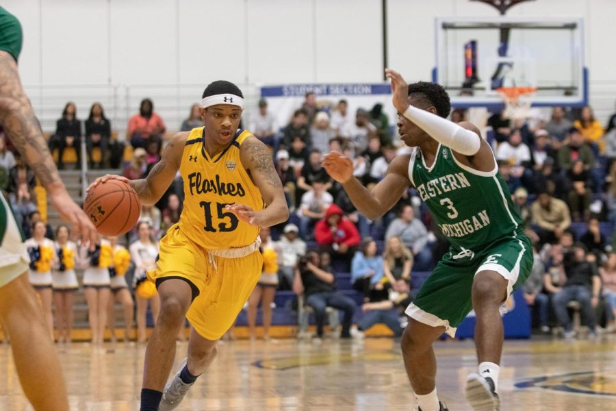 Kent State's Anthony Roberts takes the ball past Eastern Michigan's defense on Saturday, Feb. 16, 2019. He scored eight points.