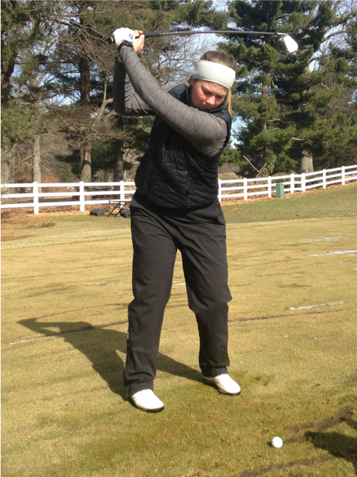 Karoline Stormo tees off at the Kent State women's golf practice facility on Feb. 19.