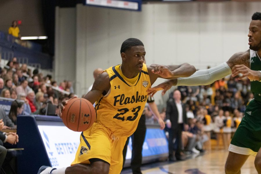 Kent senior guard Jaylin Walker makes his way towards the basketball during the first half against Eastern Michigan on Saturday. 