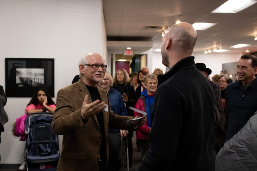 Kent State Journalism and Mass Communications professor Gary Harwood awards second place to Thomas Skala for his photo called "Verticalibration." On Friday, March 1, 2019.