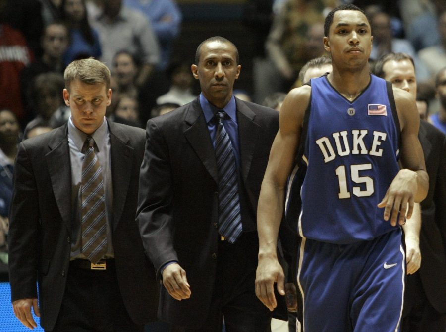 Duke's Gerald Henderson (15) leaves the court after being ejected for a flagrant foul on North Carolina's Tyler Hansbrough during the second half of a college basketball game in Chapel Hill, N.C., Sunday, March 4, 2007. North Carolina won, 86-72. From left are assistant coaches Steve Wojciechowski and Johnny Dawkins.