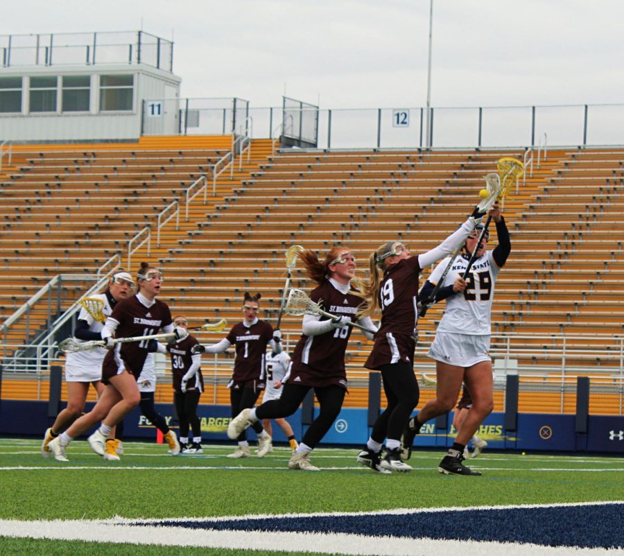 Freshman Lluna Katz attempts to steal the ball from St. Bonaventure opponents; Katz was swarmed by her defensive opponents but managed to pull through with a clean steal on March 3. 