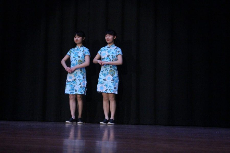 Huali Xiang models Twin Cheongsam from China. March 15, 2019