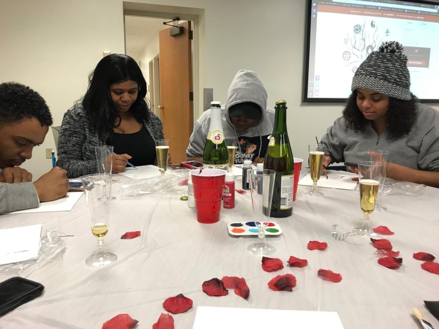 Jenell Martinez (left) and Carleshia Hernandez (far right) work on their tree paintings at KASA's "Paint &amp; Sip" event Monday, March 4.