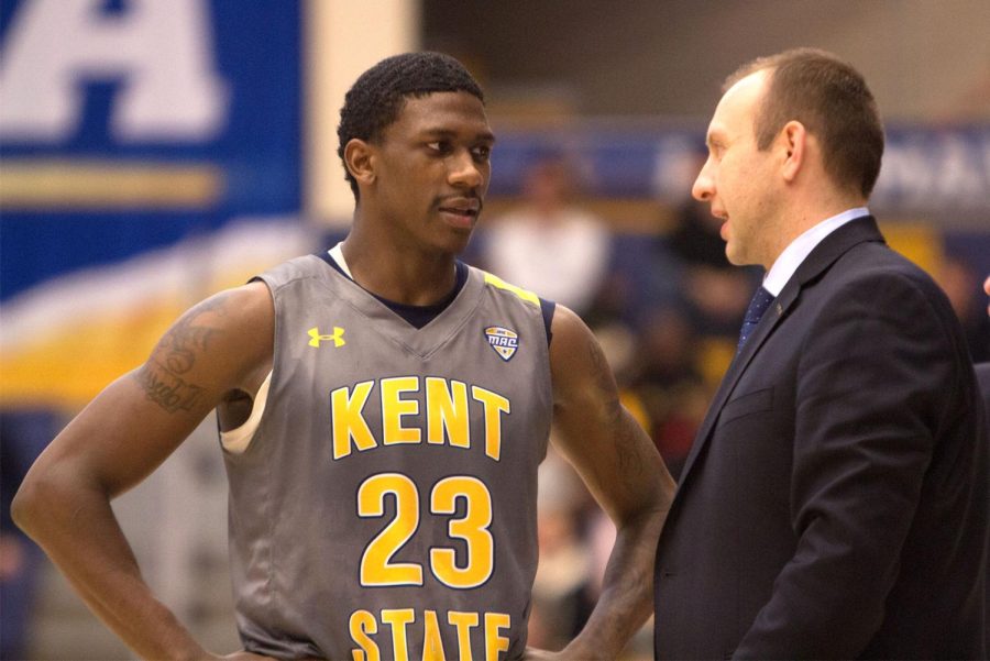 Jaylin Walker speaks with associate head coach Eric Haut during the second half of Kent State's matchup against Northern Illinois on Jan. 19. The Flashes won, 78-68.