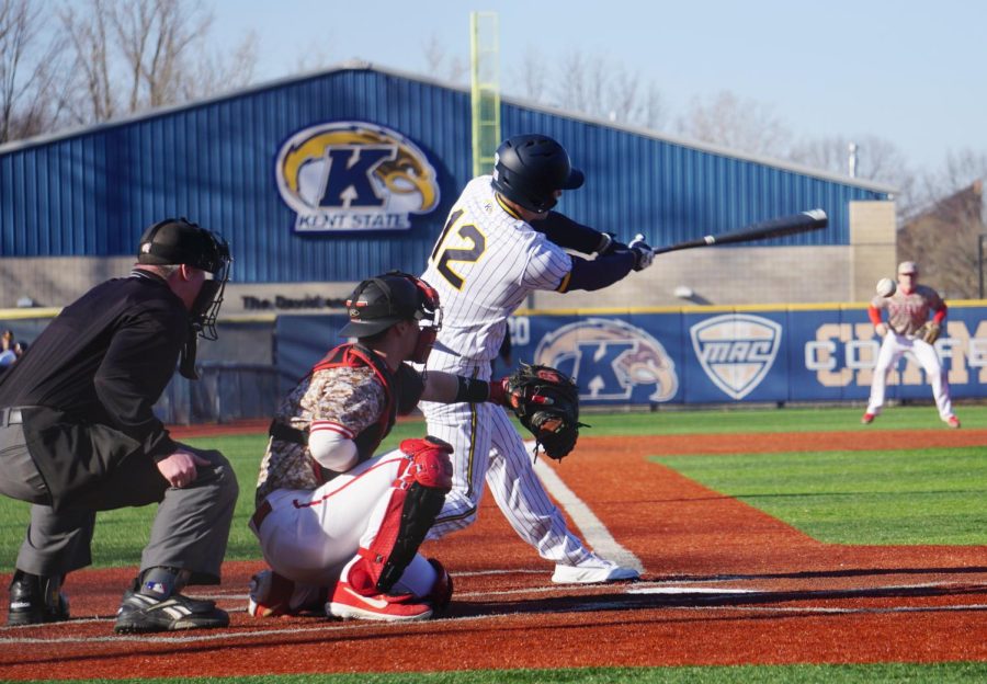 Sophomore Ben Carew slaps a line drive down the third base line against Youngstown State on March 12. Carew finished the day with three hits and two RBI.