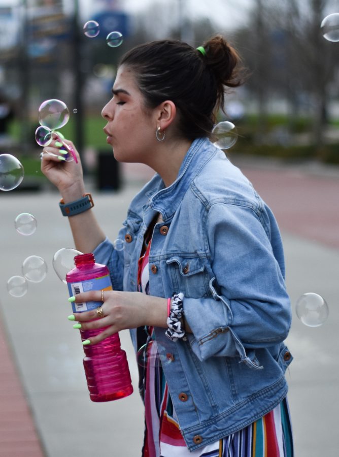 Sophomore VCD major Sarita Kunde blows bubbles at the Festival Latino, APRL 19, 2019