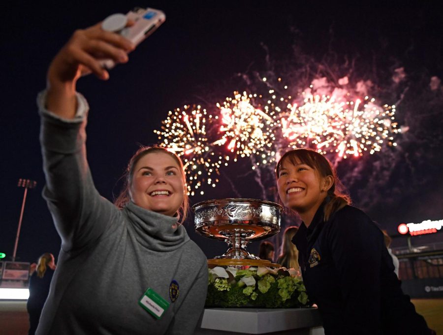 Michela Finna and Pimnipa Panthong take a selfie as they watch fireworks before the start of the Augusta Women's Championship.