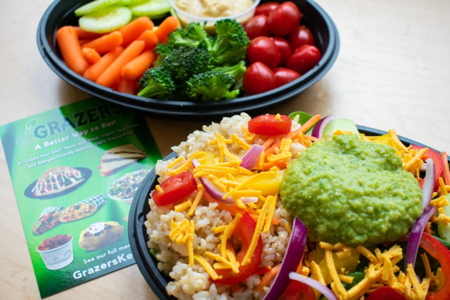 A close up of the vegan options at GRAZERS, including dipping veggies with a homemade, traditional hummus (back) and a rice bowl with vegan cheese and a homemade cilantro-lime hummus.