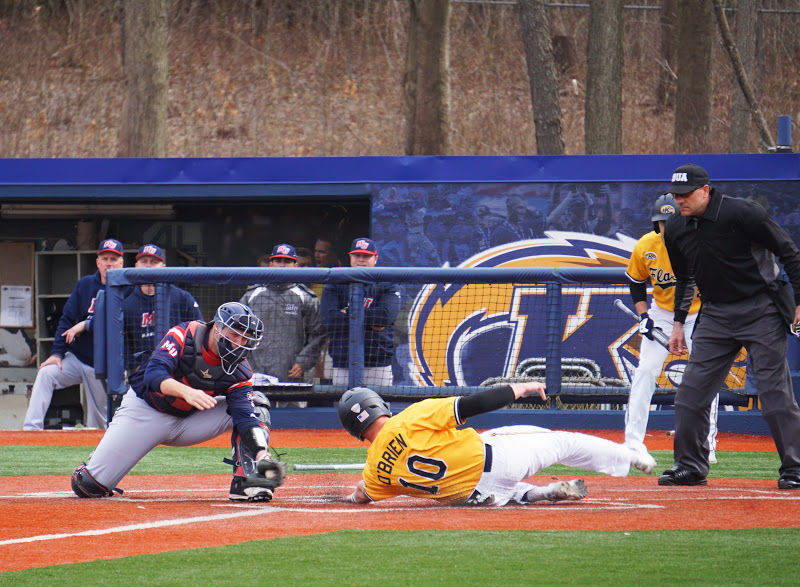 Senior Kian O'Brien slides into home after tagging up on a sacrifice fly against Malone on April 2. Kent State won, 14-6.