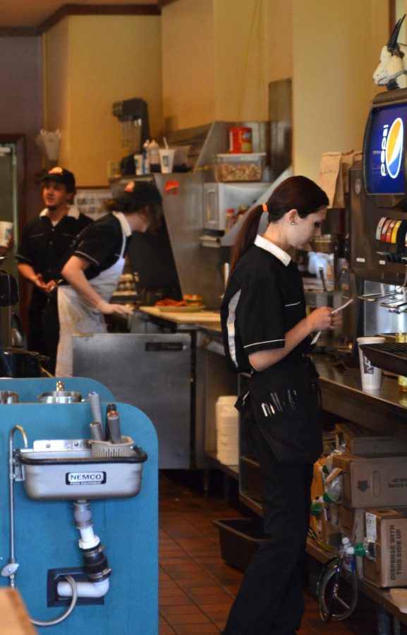 Alex Kozlowski, an employee at Wild Goats Cafe, reads a customer ticket on April 20, 2016. FILE.