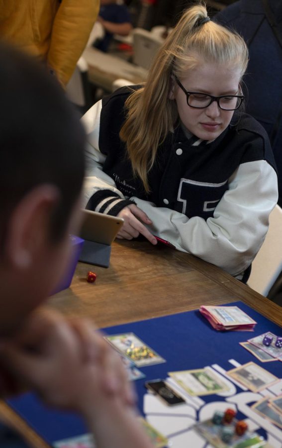 Natalie Shampay watches a Pokemon game on Wednesday night at Full Grip Games in Akron.