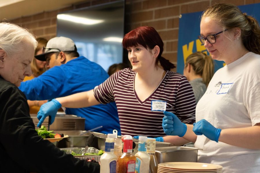 Kent State Campus Kitchen volunteers serve food to a Kentway Resident on April 23. 