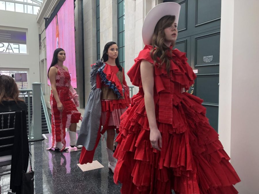 Models walk through the Rockwell Hall atrium in designer Tatum Reusser's "Scarlet Is She" line on Friday, April 26, 2019.